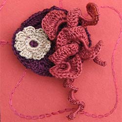 coral and burgundy crochet brooch